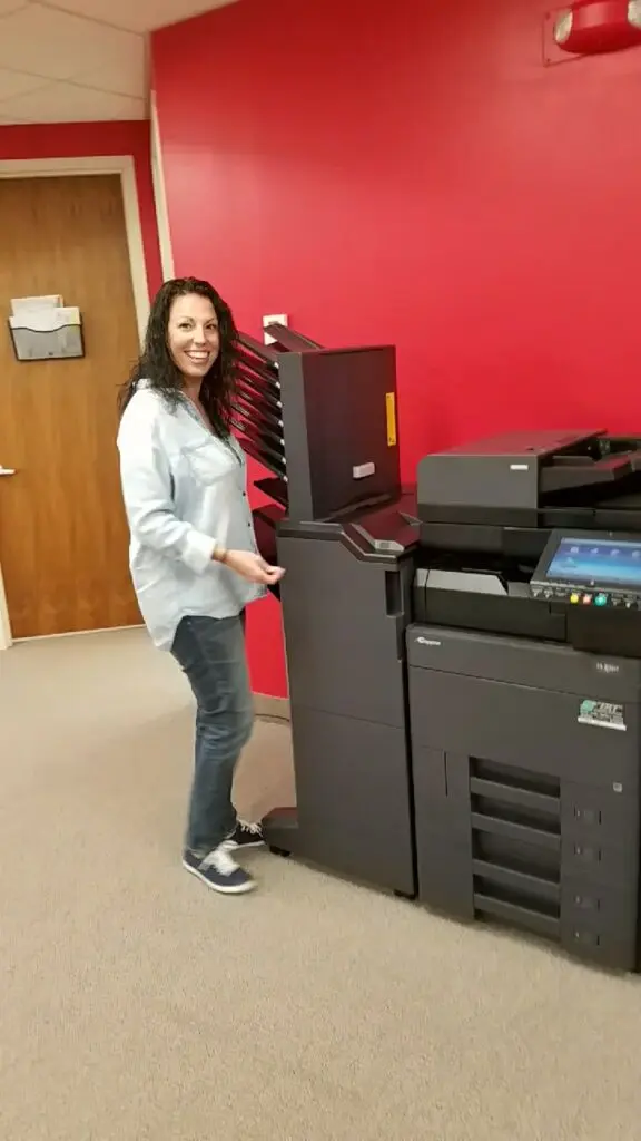 Office equipment specialist reviewing a copier lease quote with a customer