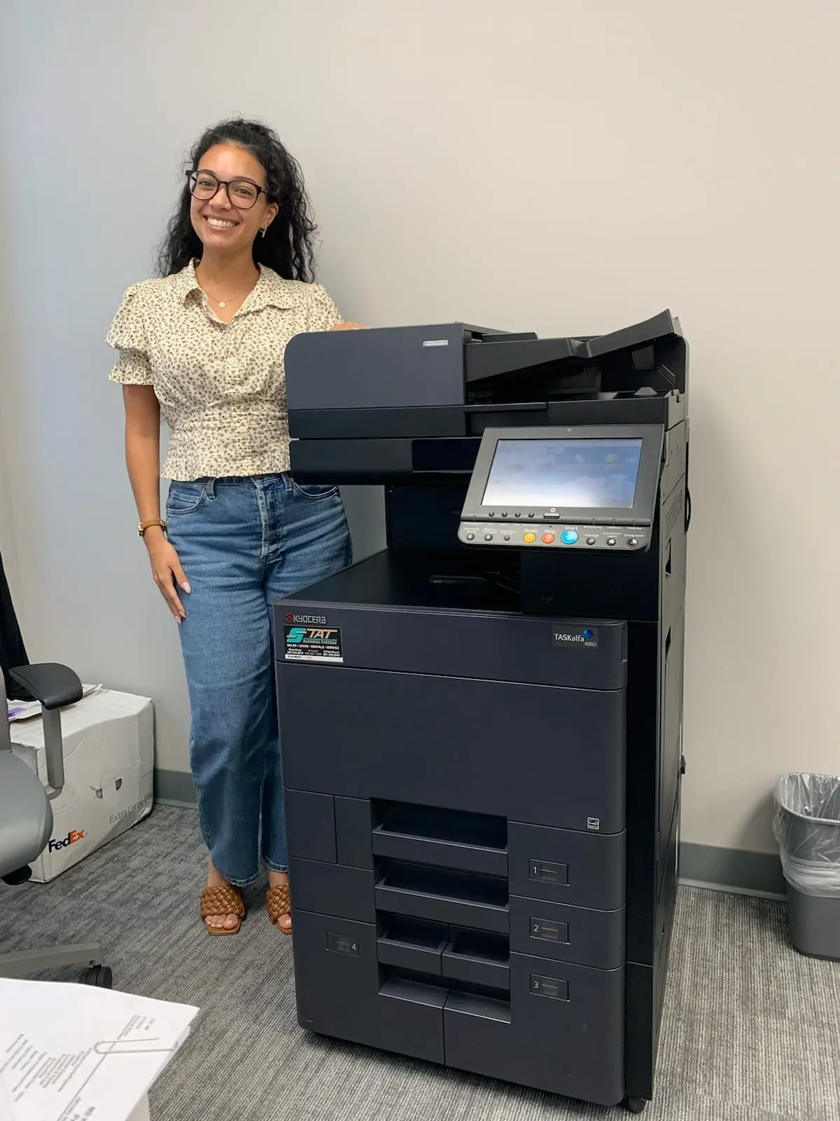 Office employee receiving guidance on multifunction copier controls
