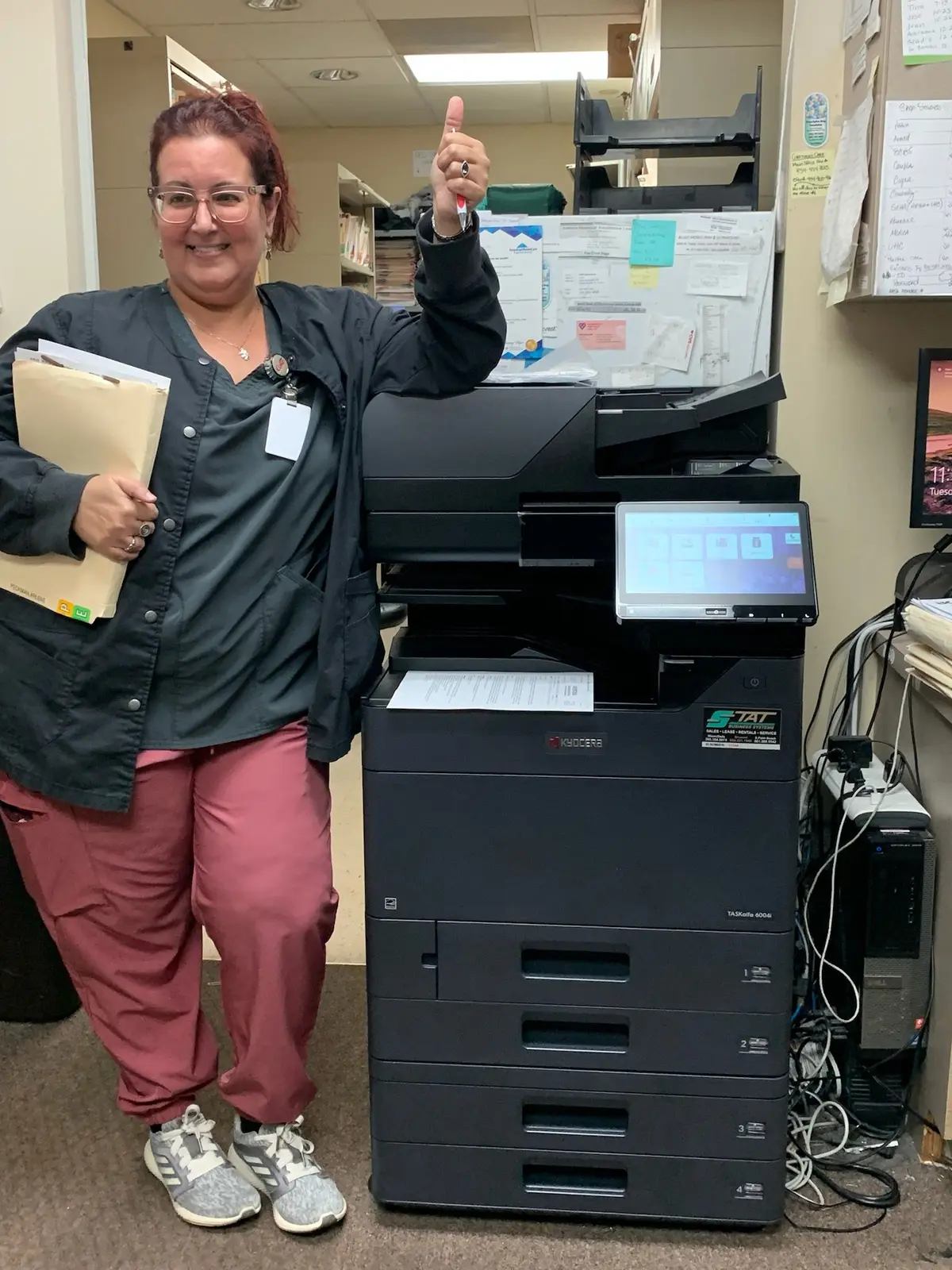Employee using a Kyocera multifunction copier scanning interface