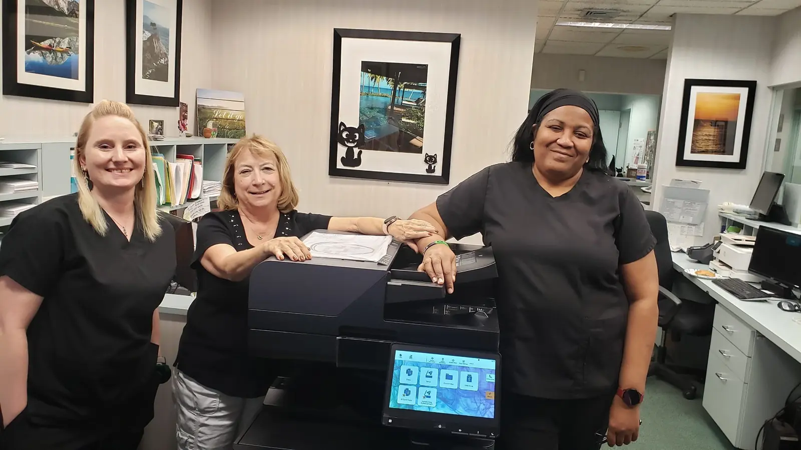 Office employee beside a properly sized multifunction copier