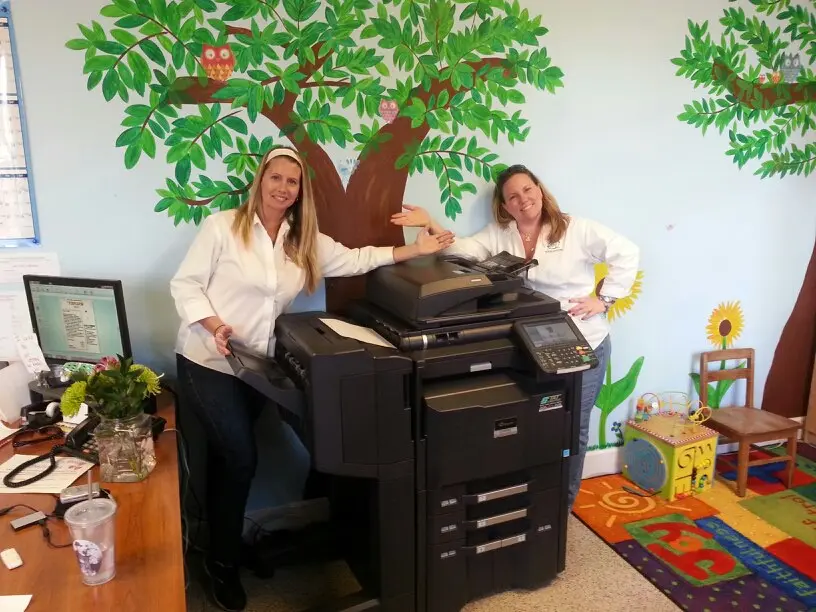 South Florida business customer beside a newly installed copier